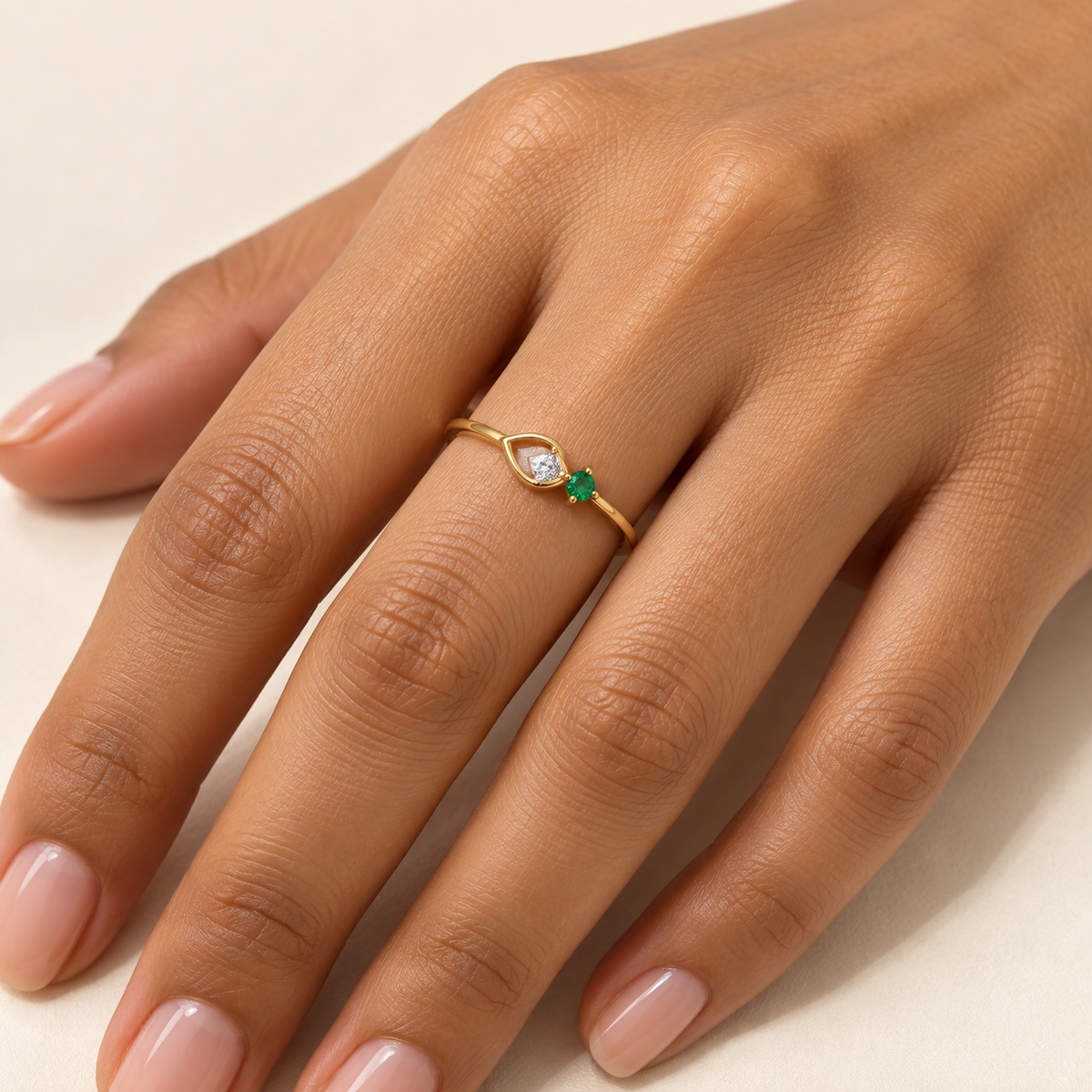 emerald-accented gold teardrop ring