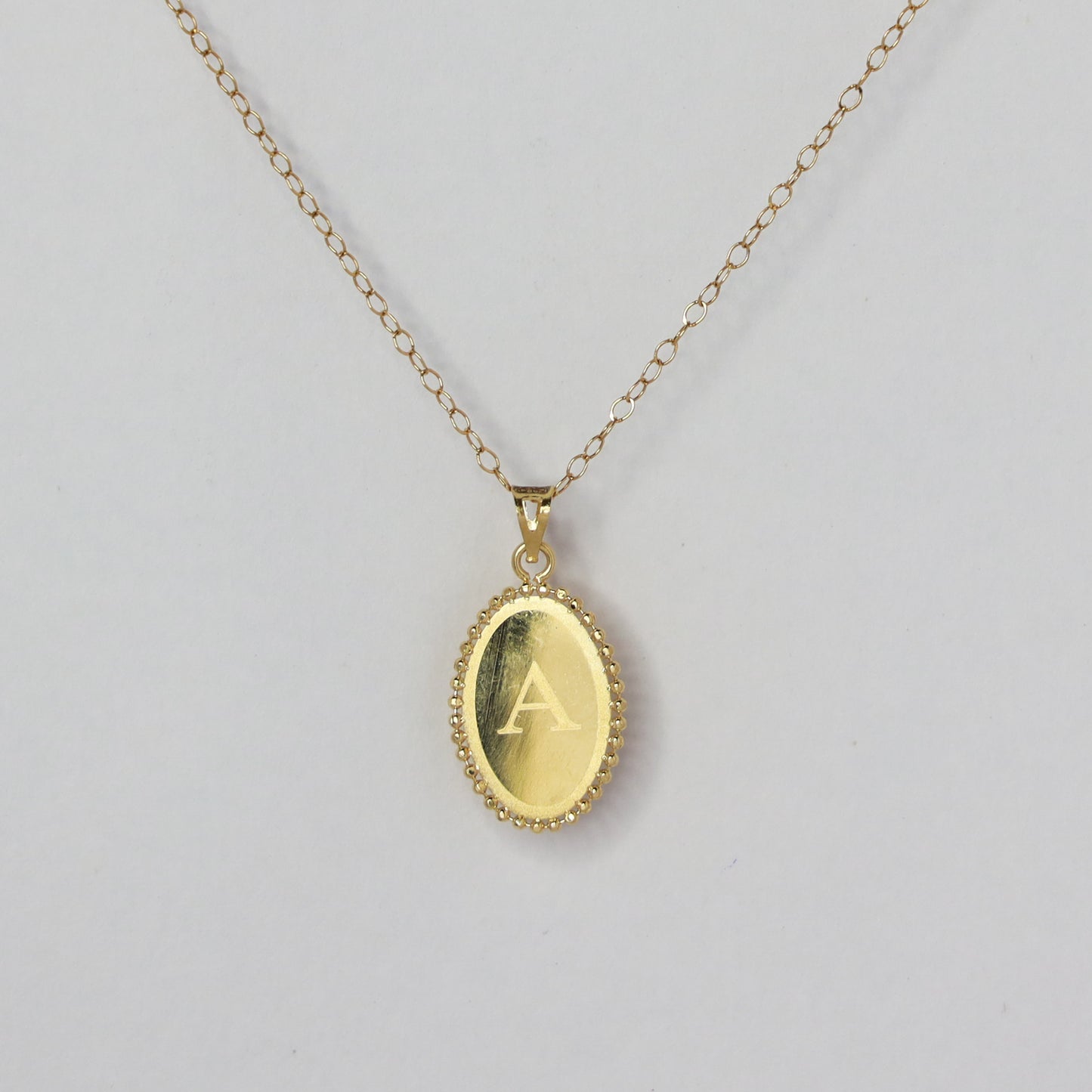 oval letter a 18kt gold pendant